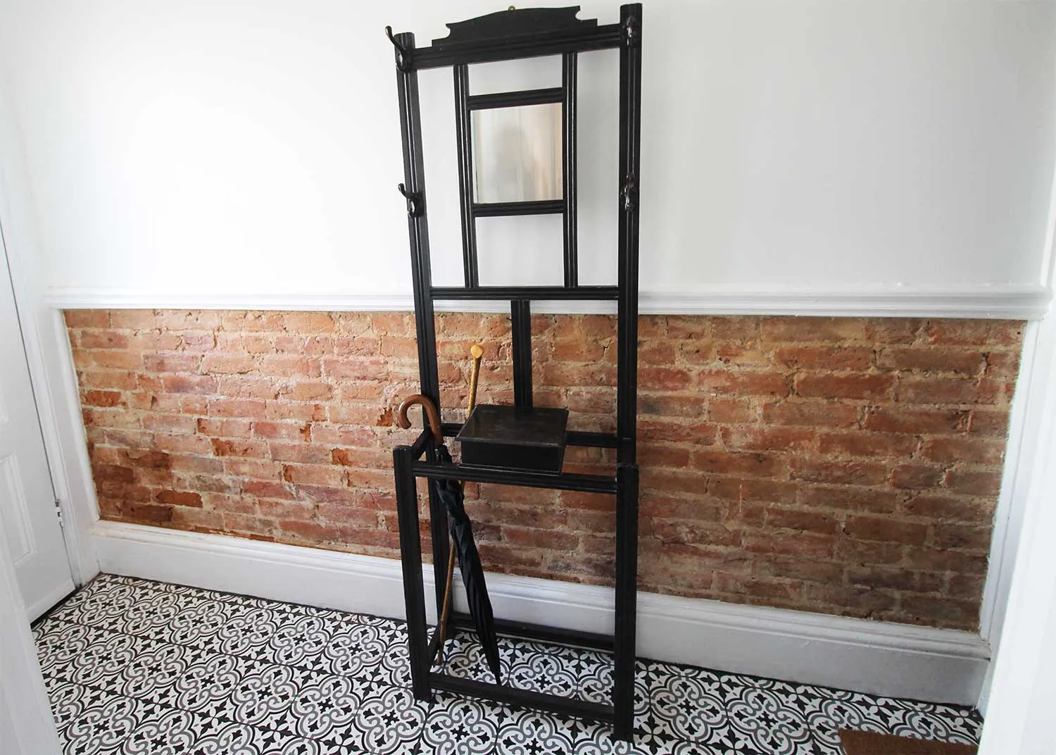 The hallway walls were stripped back exposing the brick and then redecorated